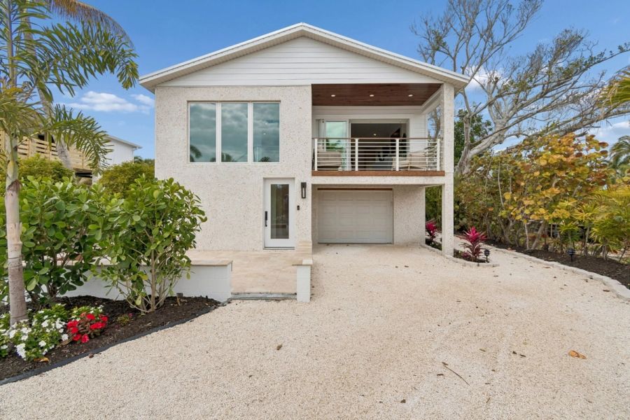 Coastal home exterior front entrance white stucco — New home construction, Longboat Key