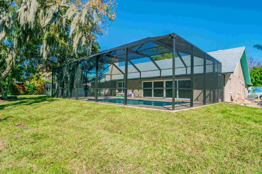 Backyard pool enclosure side view — Custom home addition, pool, and renovation, Bradenton