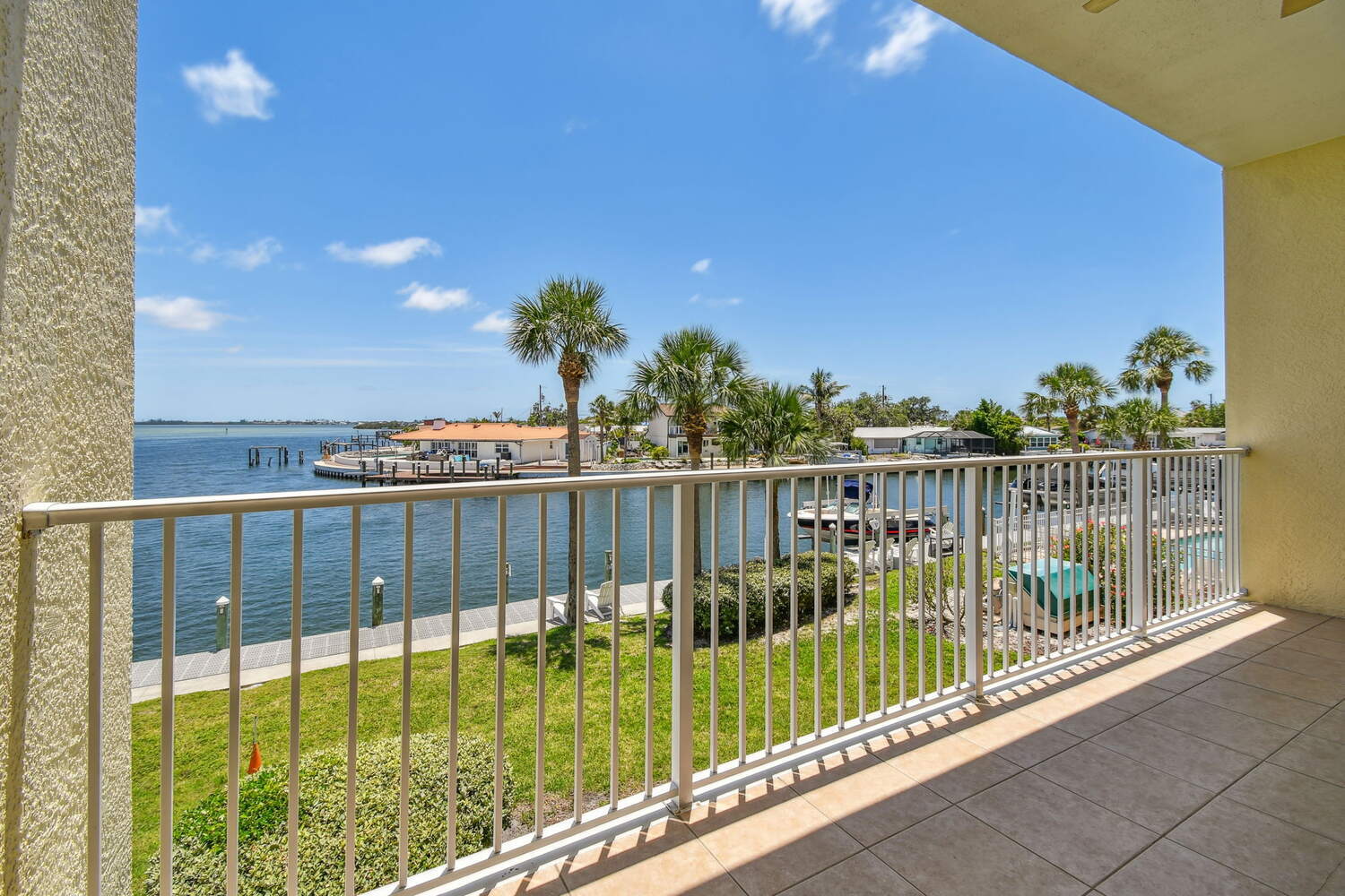 Coastal balcony scene with lush landscaping and water access — Waterfront condo renovation, Bradenton, FL