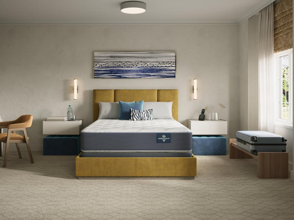 Concierge Suite Firm mattress made up with bedding in a bedroom