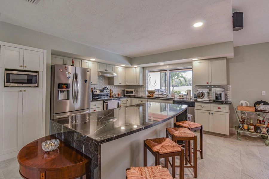 Kitchen fridge island round table — Custom design-build near IMG Academy, West Bradenton