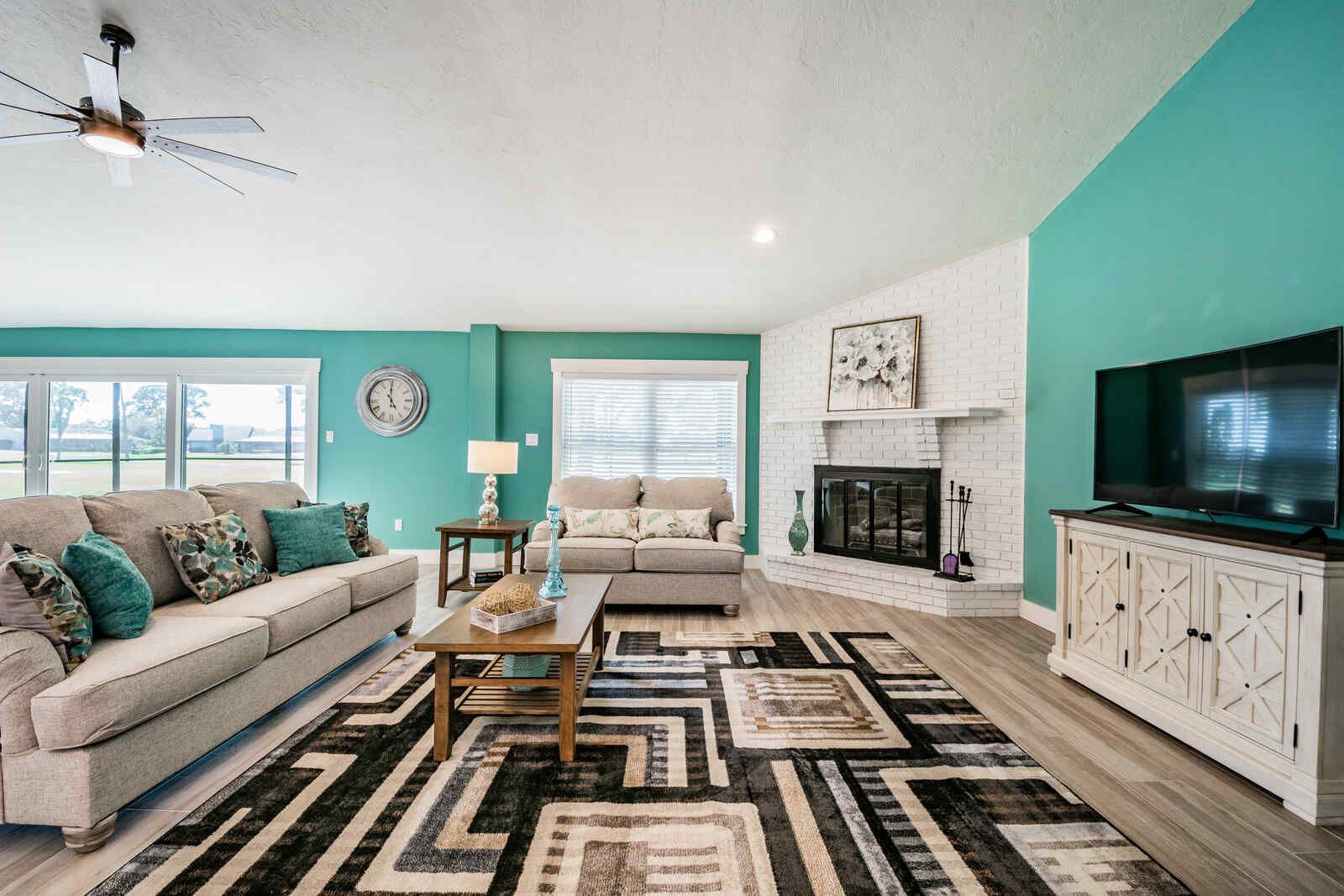 Living room with sofa loveseat and fireplace — Custom home addition, pool, and renovation, Bradenton