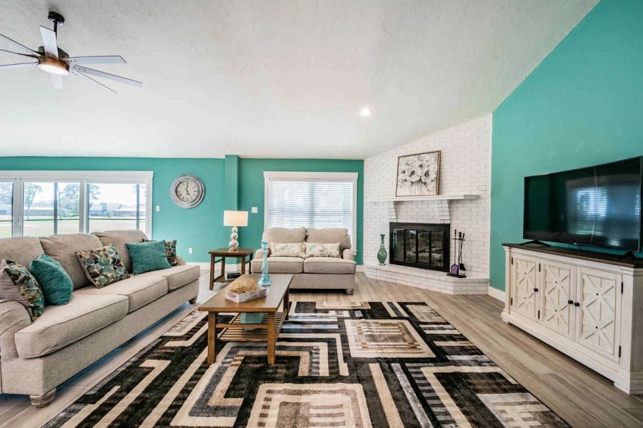 Living room with sofa loveseat and fireplace — Custom home addition, pool, and renovation, Bradenton
