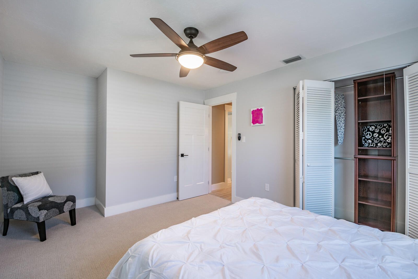 Bedroom accent chair and closet bookshelf — Custom home addition, pool, and renovation, Bradenton