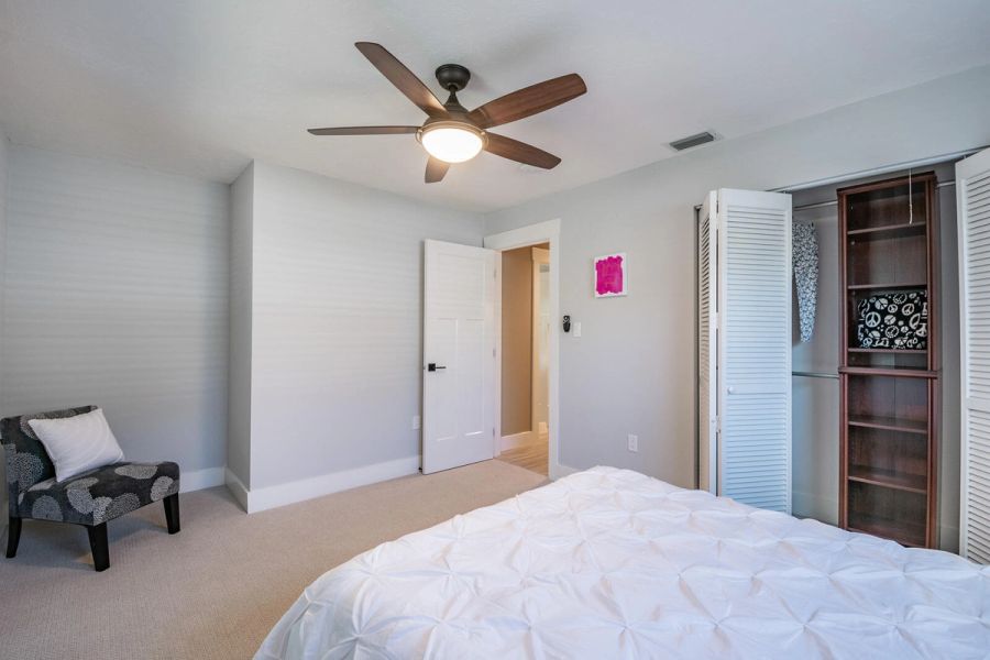 Bedroom accent chair and closet bookshelf — Custom home addition, pool, and renovation, Bradenton