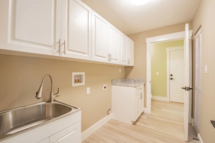 Laundry room with sink and granite counter — Custom home addition, pool, and renovation, Bradenton