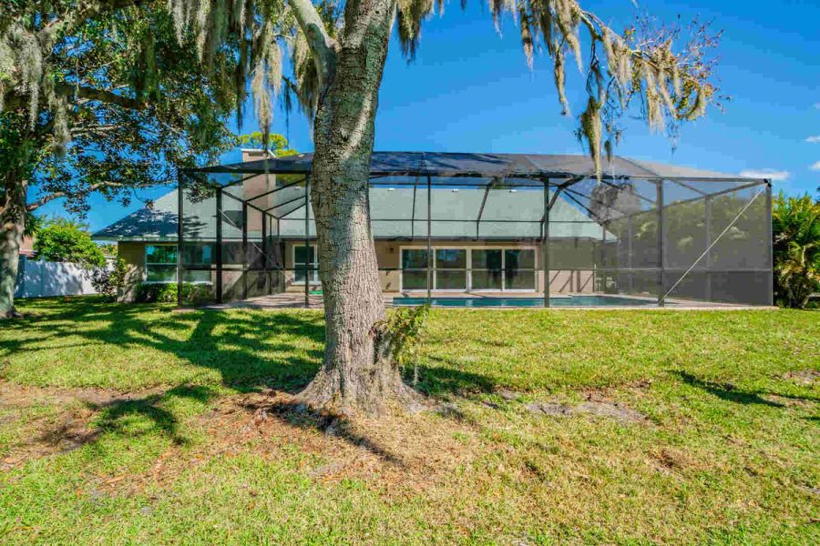 Backyard pool enclosure exterior view — Custom home addition, pool, and renovation, Bradenton