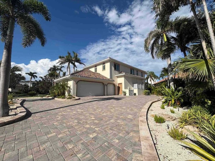 Front exterior with landscaped paver drive — Custom home addition, Cortez