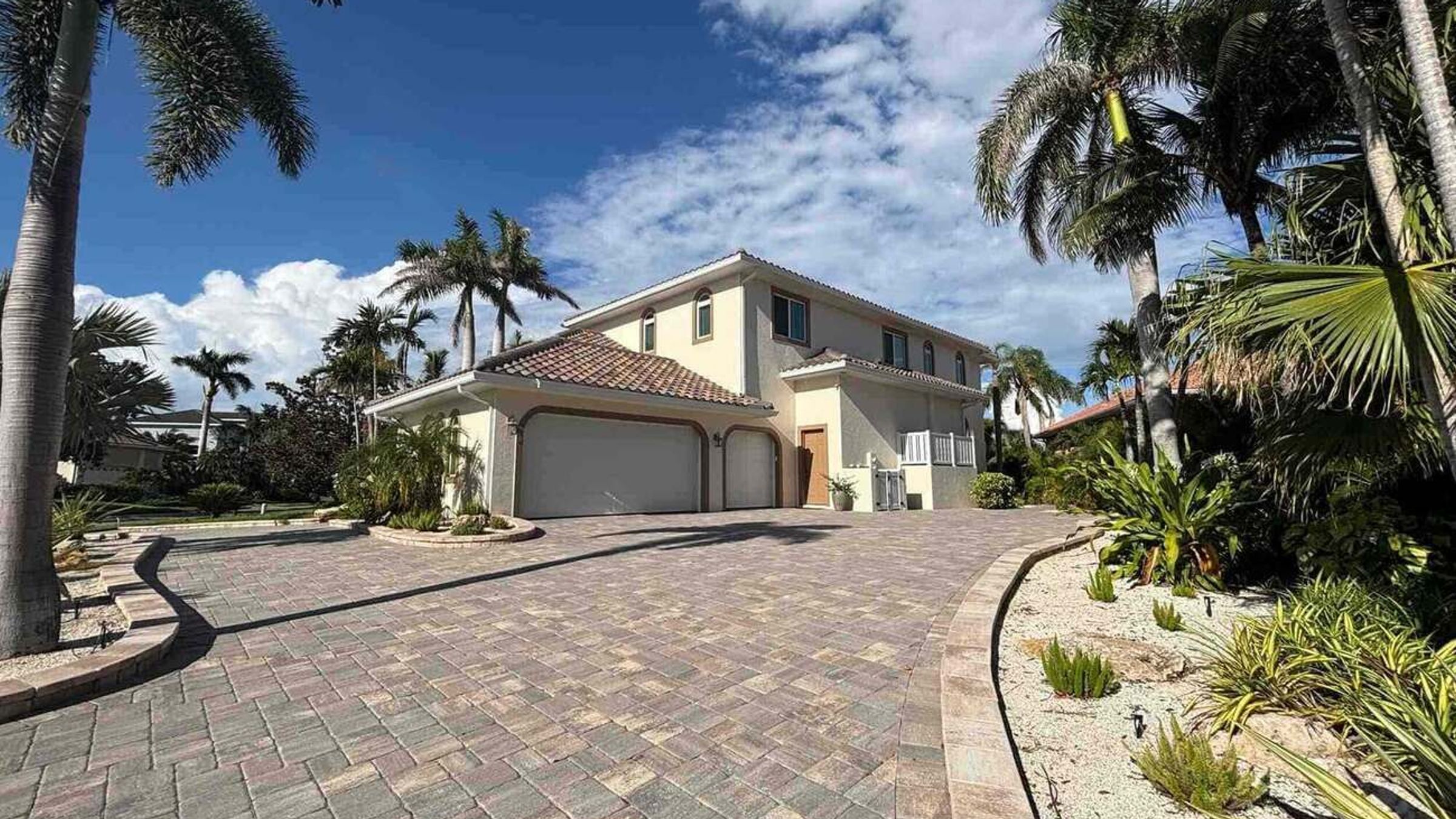 Front exterior with landscaped paver drive — Custom home addition, Cortez