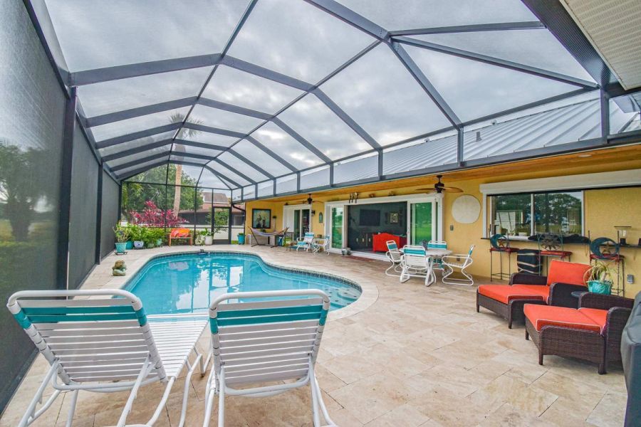 Lanai pool red cushions sliding doors — Custom design-build near IMG Academy, West Bradenton