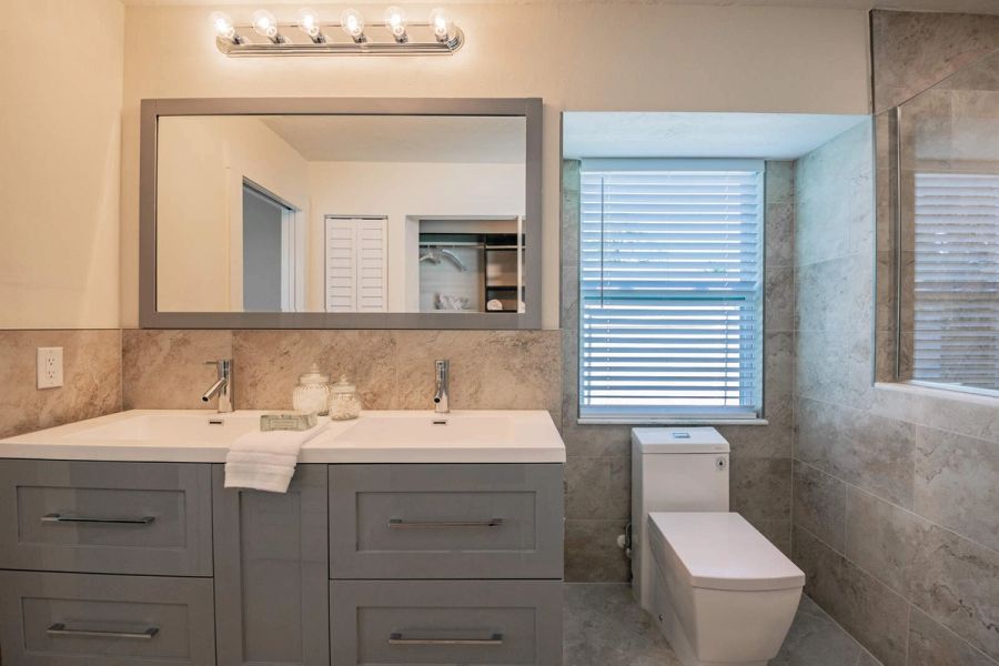 Primary bathroom double vanity and toilet — Custom home addition, pool, and renovation, Bradenton