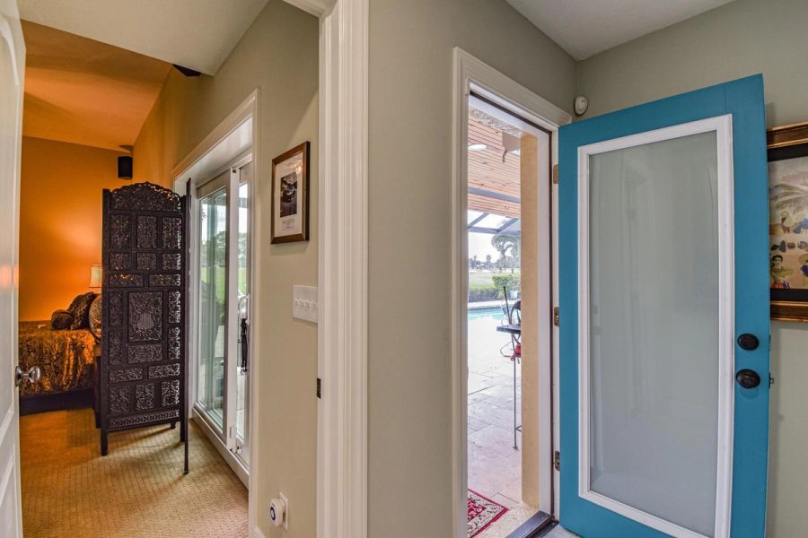 Hallway teal front door pool view — Custom design-build near IMG Academy, West Bradenton