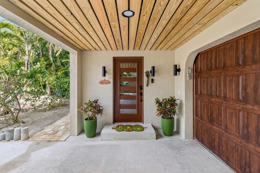 Exterior covered entry wood ceiling modern front door glass panels — Custom home addition, Longboat Key