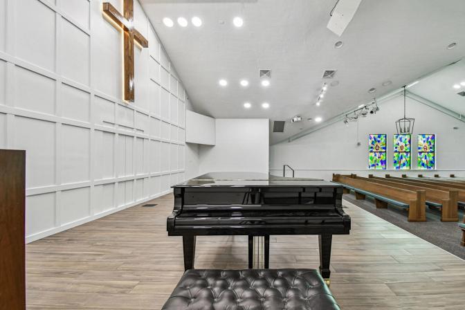 Backstage view of piano area and cross wall in custom Anna Maria sanctuary by Adkins Building & Construction