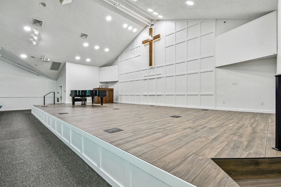 Wide-angle view of custom stage with wood flooring — Roser Memorial Community Church, Anna Maria, FL