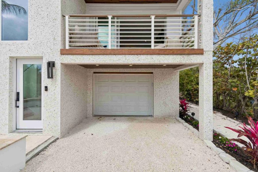 Garage door balcony gravel driveway — New home construction, Longboat Key