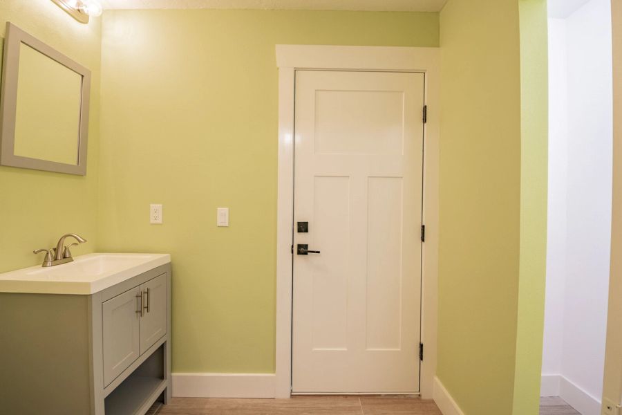 Bathroom with green walls and vanity — Custom home addition, pool, and renovation, Bradenton