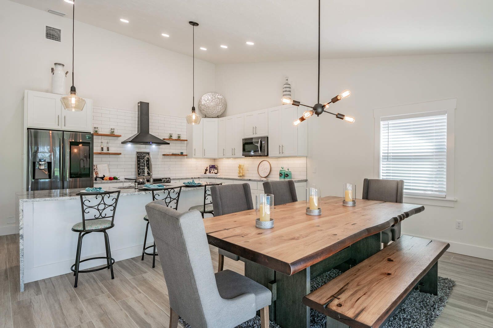 Dining table with bench and pendant lights — Custom home addition, pool, and renovation, Bradenton
