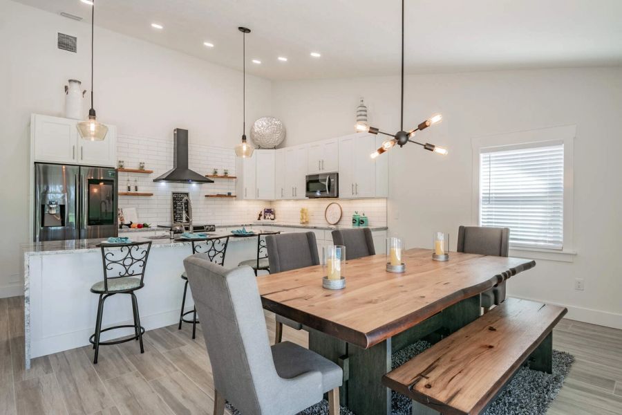 Dining table with bench and pendant lights — Custom home addition, pool, and renovation, Bradenton