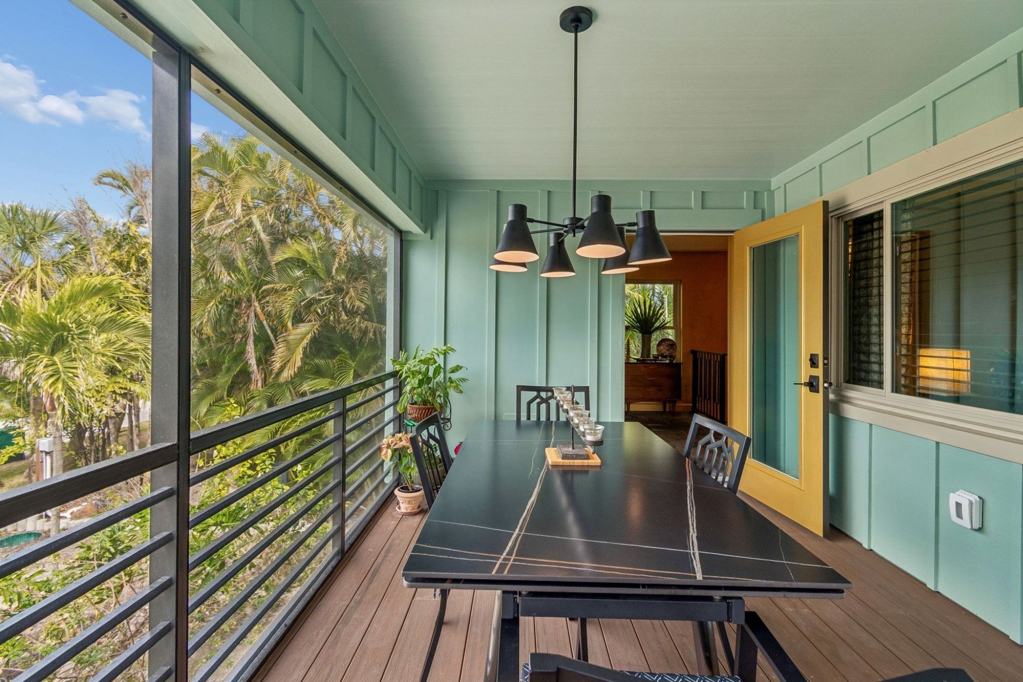 Exterior screened porch dining area black table pendant light — Custom home addition, Longboat Key