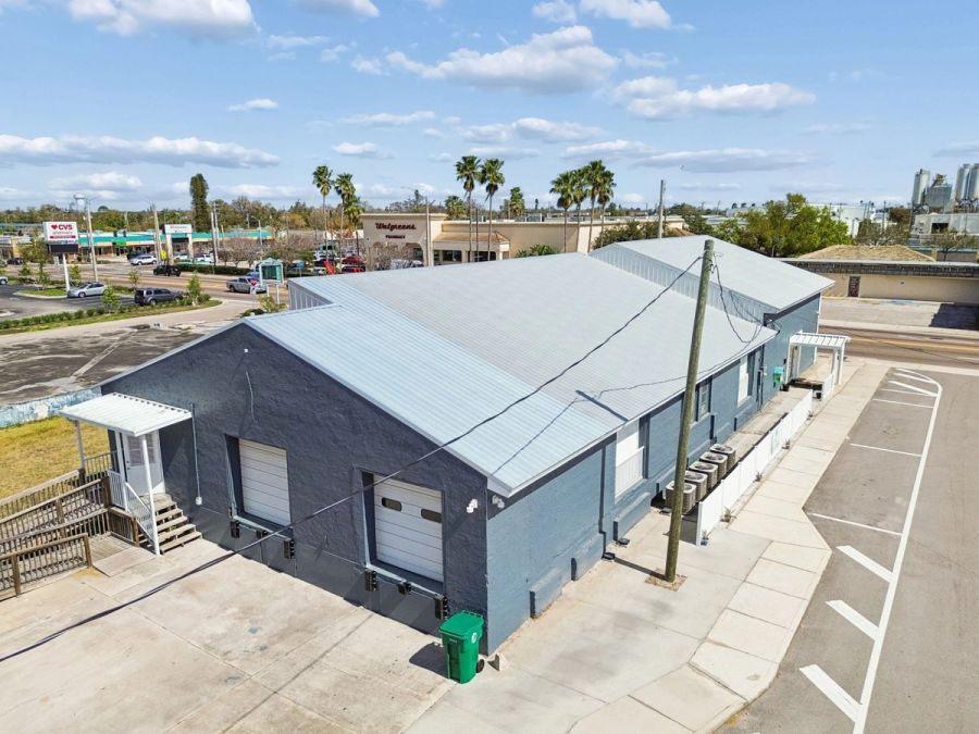 Aerial gray stucco metal roof corner lot — Commercial building renovation, Palmetto