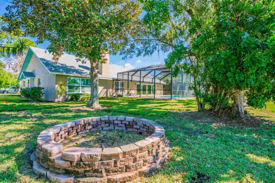 Backyard fire pit and pool enclosure — Custom home addition, pool, and renovation, Bradenton