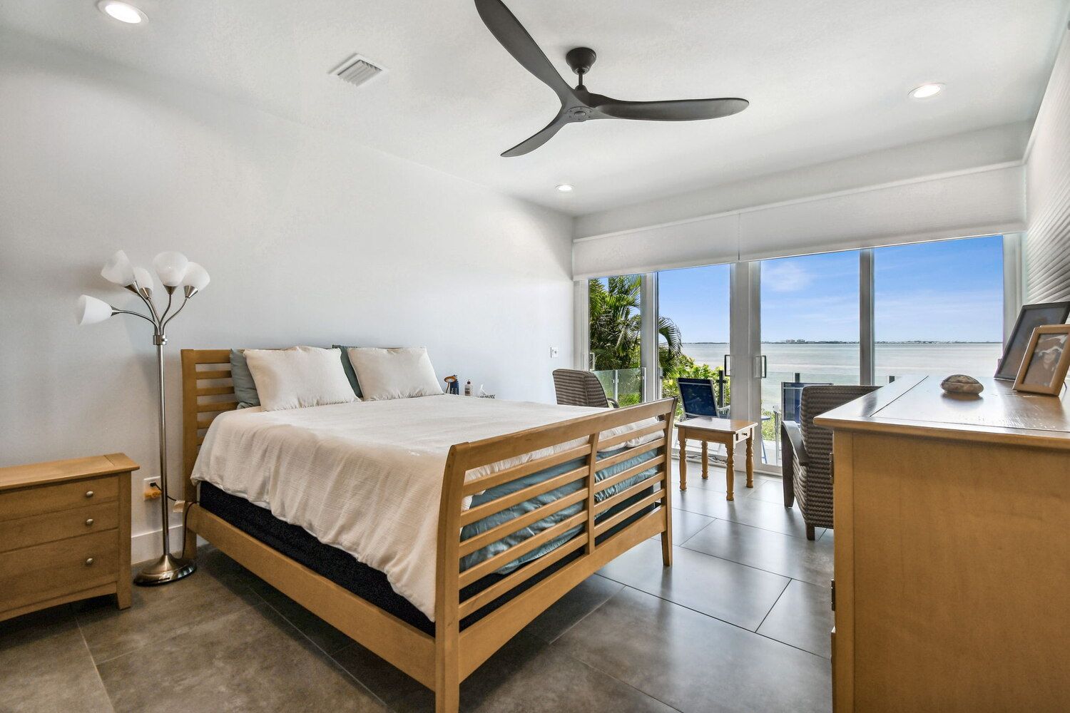 Waterfront master bedroom with private balcony and glass doors — Waterfront home renovation, Bradenton, FL