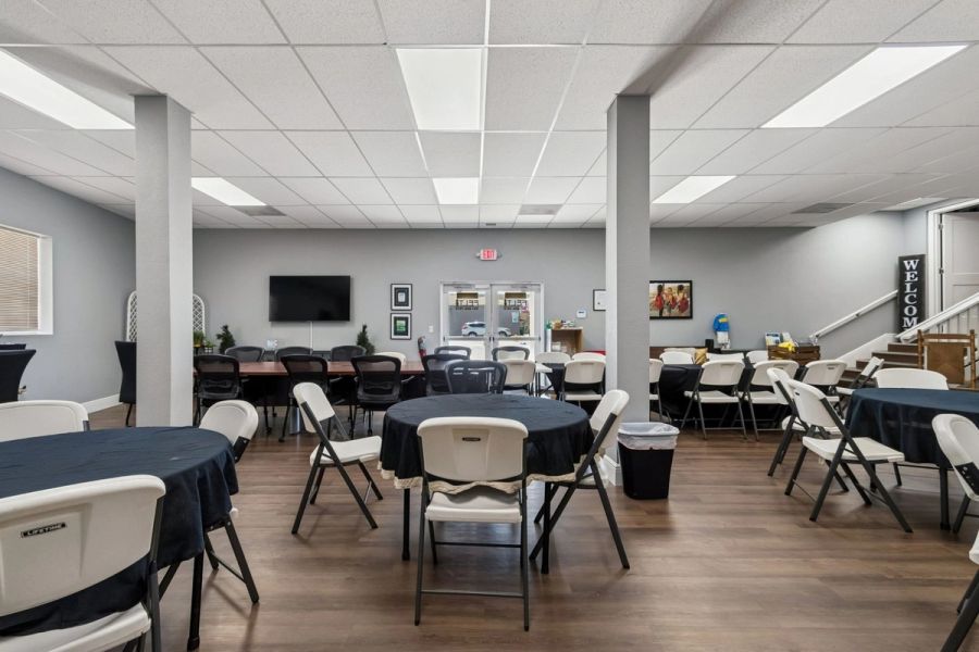 Interior commercial community room conference table round tables drop ceiling wood floors — Commercial building renovation, Palmetto