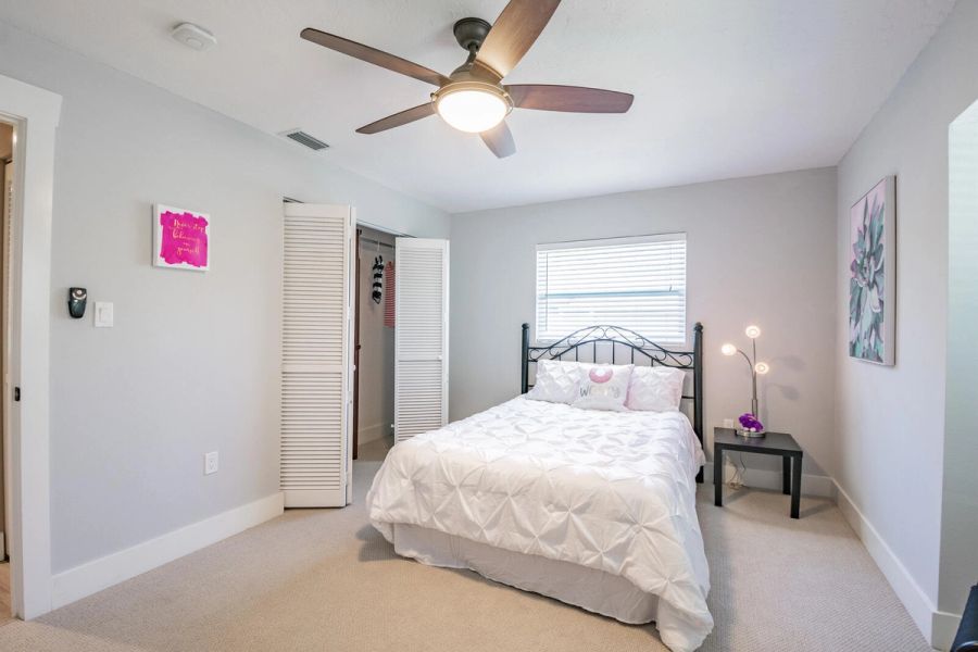 Bedroom pink accent art and closet — Custom home addition, pool, and renovation, Bradenton