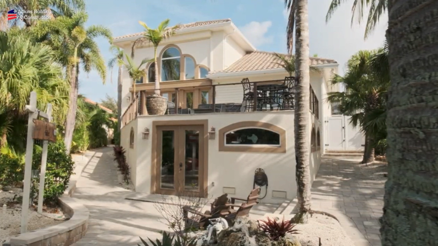 Rear elevation with balconies and tropical landscaping — Custom home addition, Cortez
