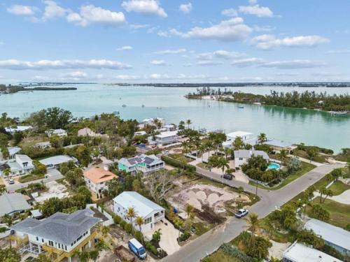 Aerial drone view coastal neighborhood waterway turquoise water palm trees — New home construction, Longboat Key