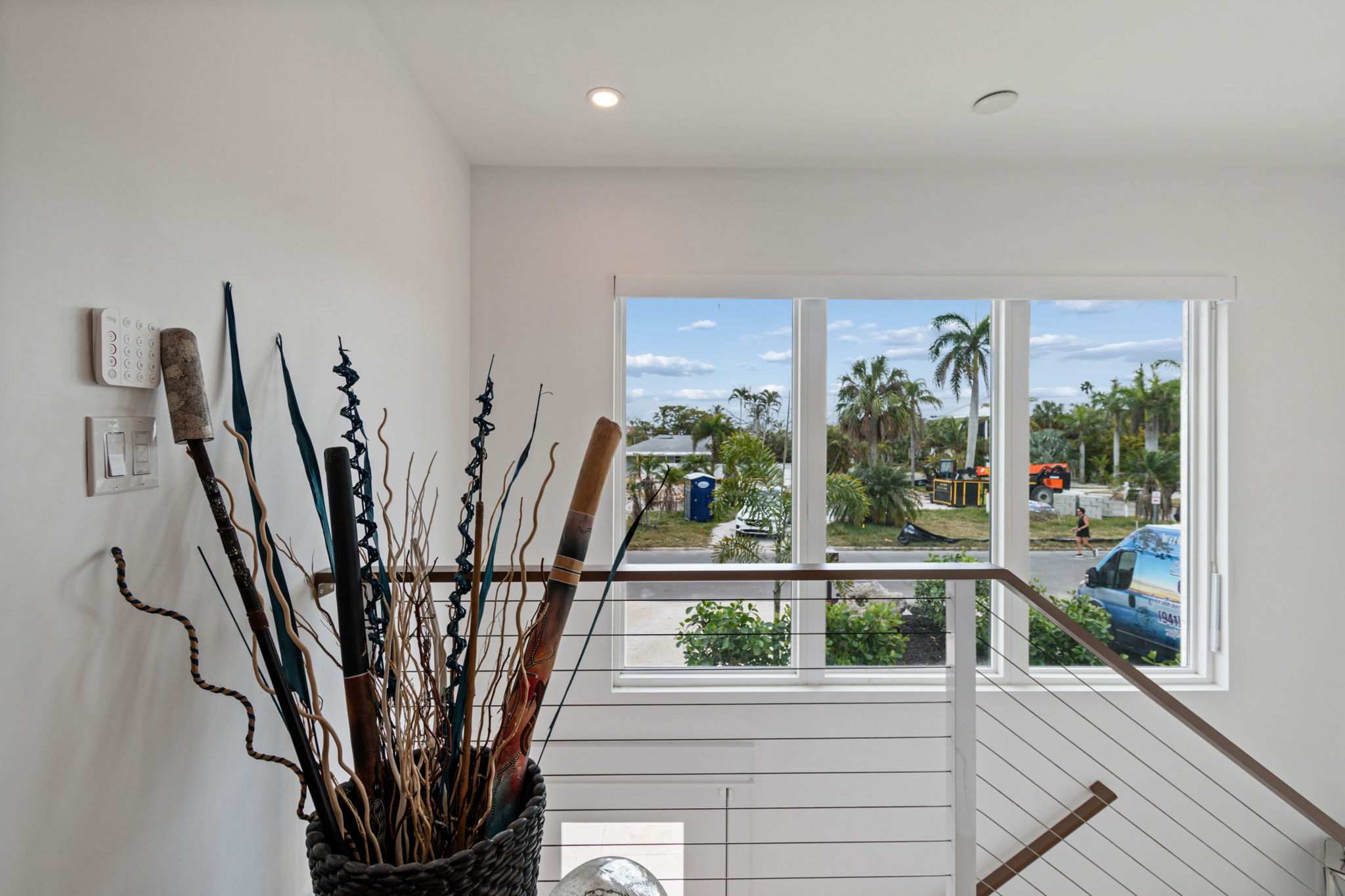 Interior staircase landing window palm tree view — New home construction, Longboat Key