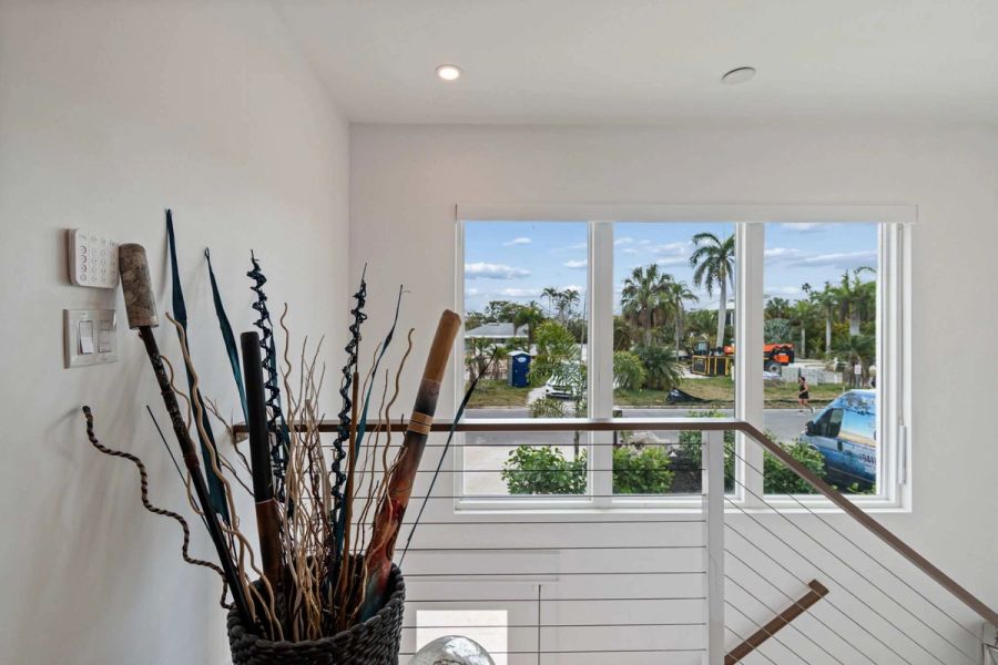 Interior staircase landing window palm tree view — New home construction, Longboat Key