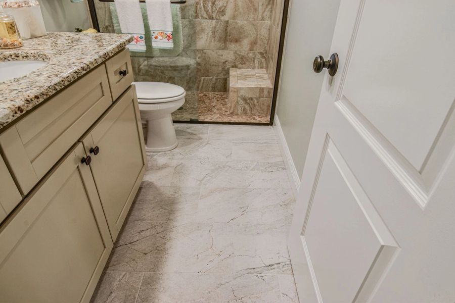 Guest bath vanity shower pebble floor — Custom design-build near IMG Academy, West Bradenton