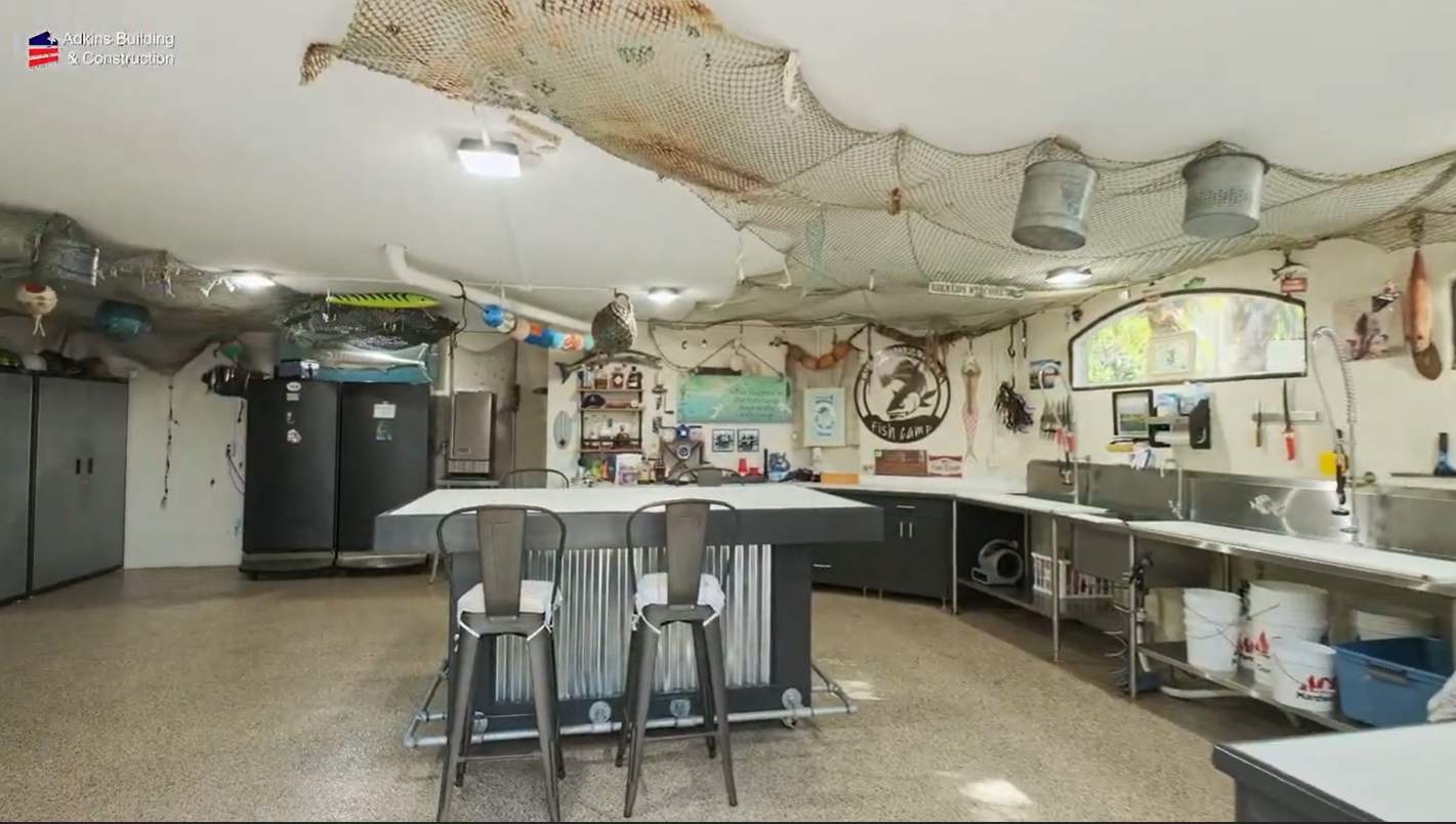 Fish camp room with island seating and open workshop space — Custom home addition, Cortez