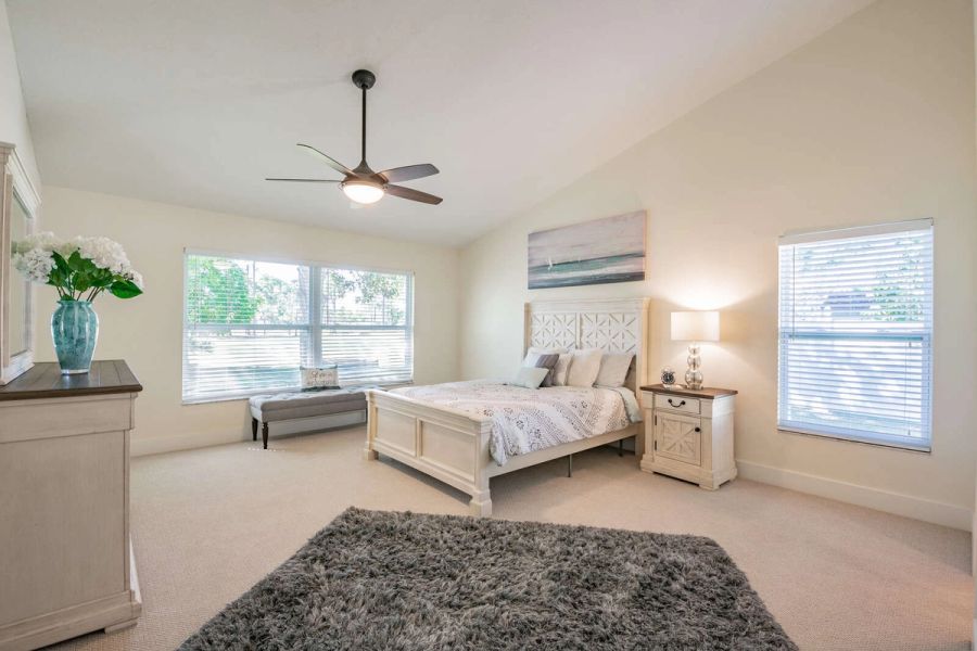 Primary bedroom with bed and window bench — Custom home addition, pool, and renovation, Bradenton