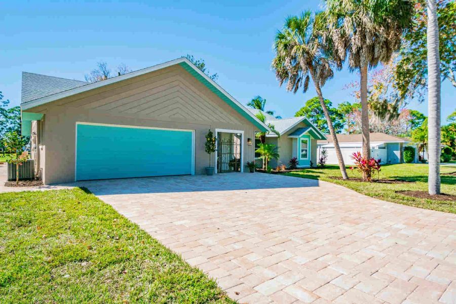 Exterior teal garage door and driveway — Custom home addition, pool, and renovation, Bradenton