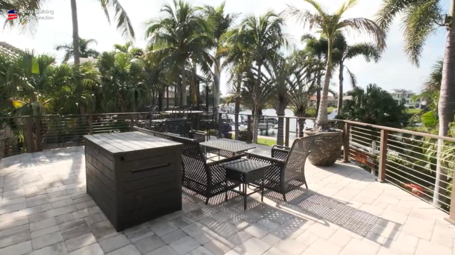 Rooftop terrace with outdoor dining set and cable railing — Custom home addition, Cortez
