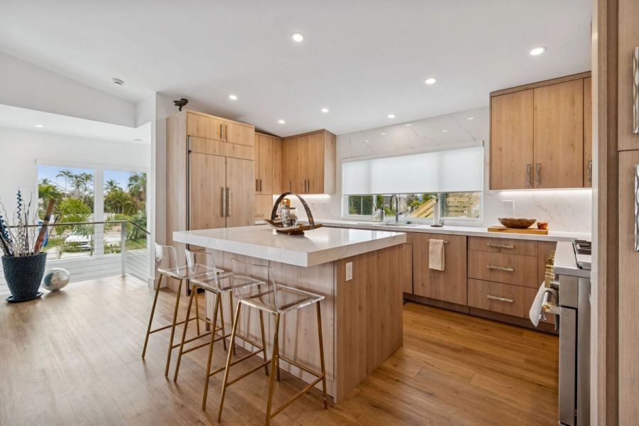 Interior kitchen island quartz countertop bar stools wood cabinets — New home construction, Longboat Key