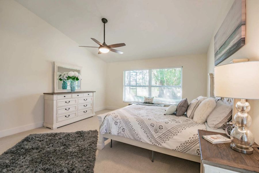 Primary bedroom with dresser and nightstand — Custom home addition, pool, and renovation, Bradenton