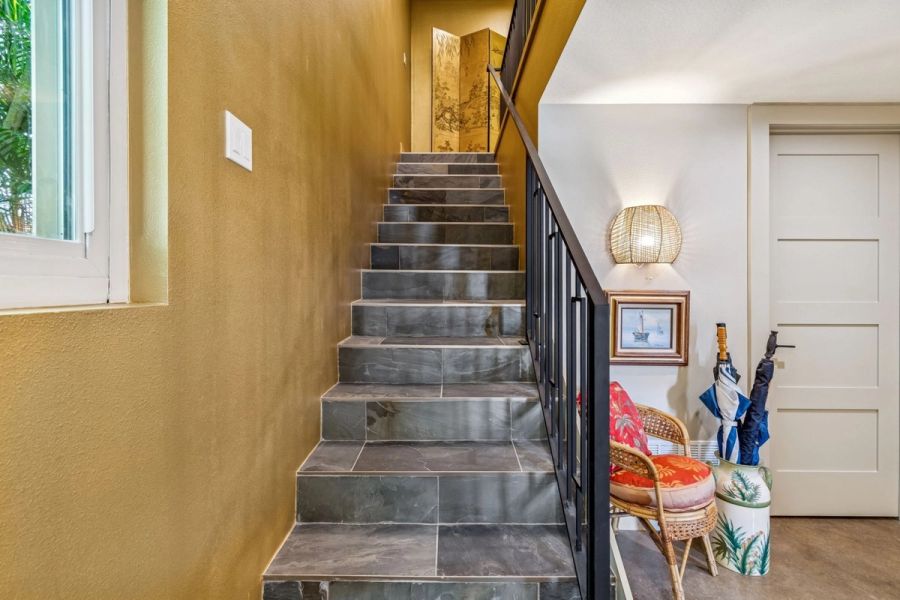 Interior staircase slate tile steps iron railing gold accent wall — Custom home addition, Longboat Key