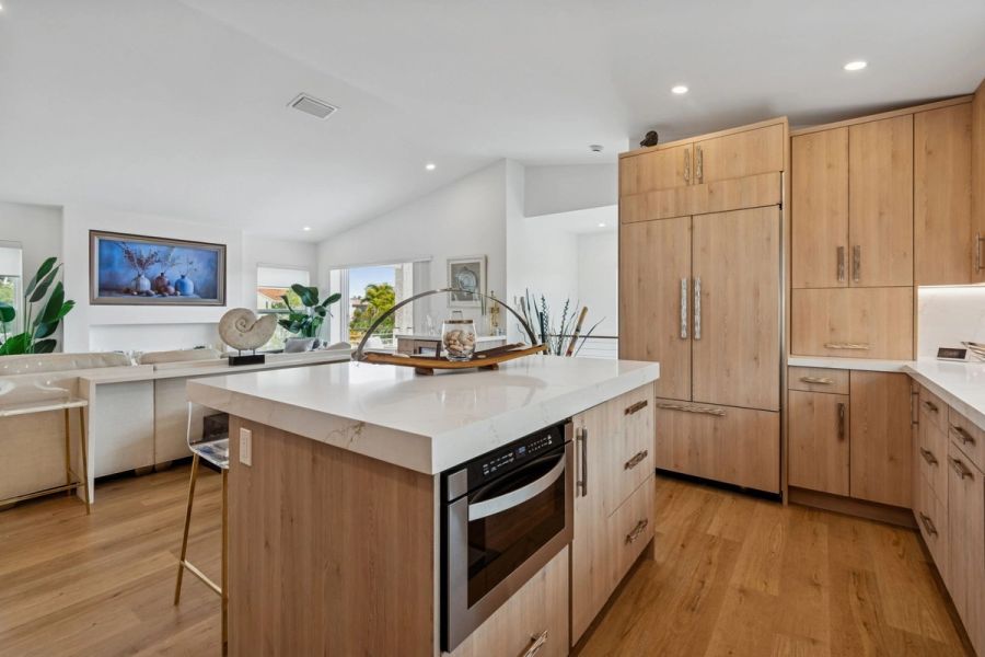 Interior kitchen island microwave drawer quartz countertop open to living room — New home construction, Longboat Key
