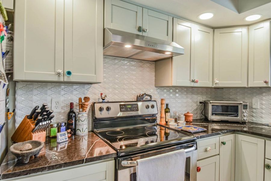 Kitchen range hood colorful knobs — Custom design-build near IMG Academy, West Bradenton