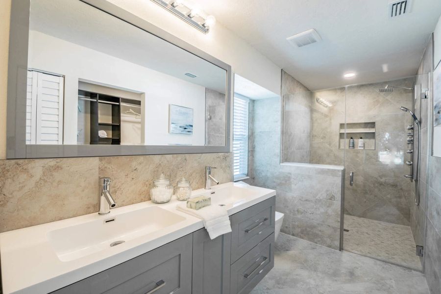 Primary bathroom with double vanity and walk-in shower — Custom home addition, pool, and renovation, Bradenton