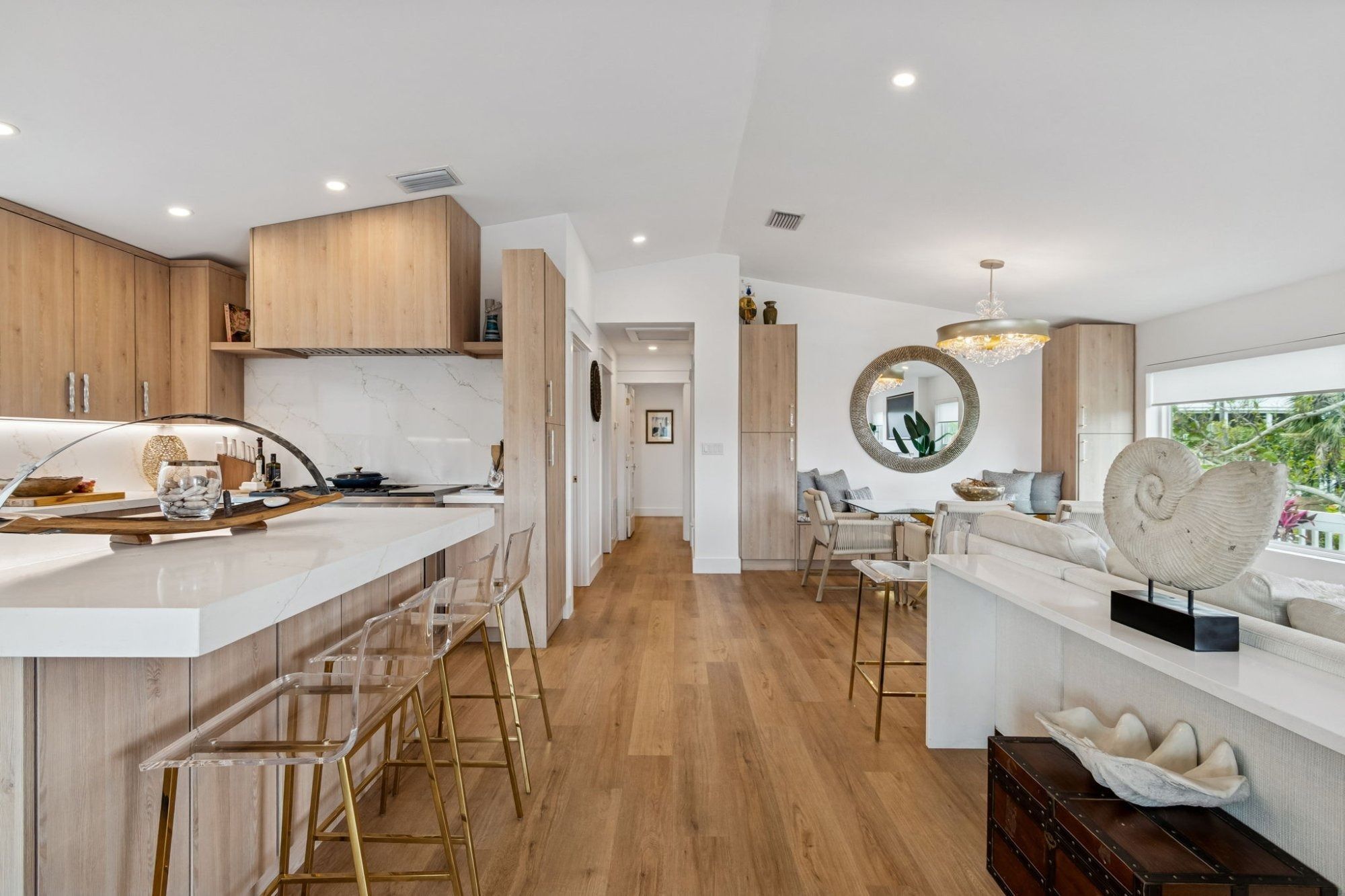 Interior kitchen island bar seating open to living dining room — New home construction, Longboat Key