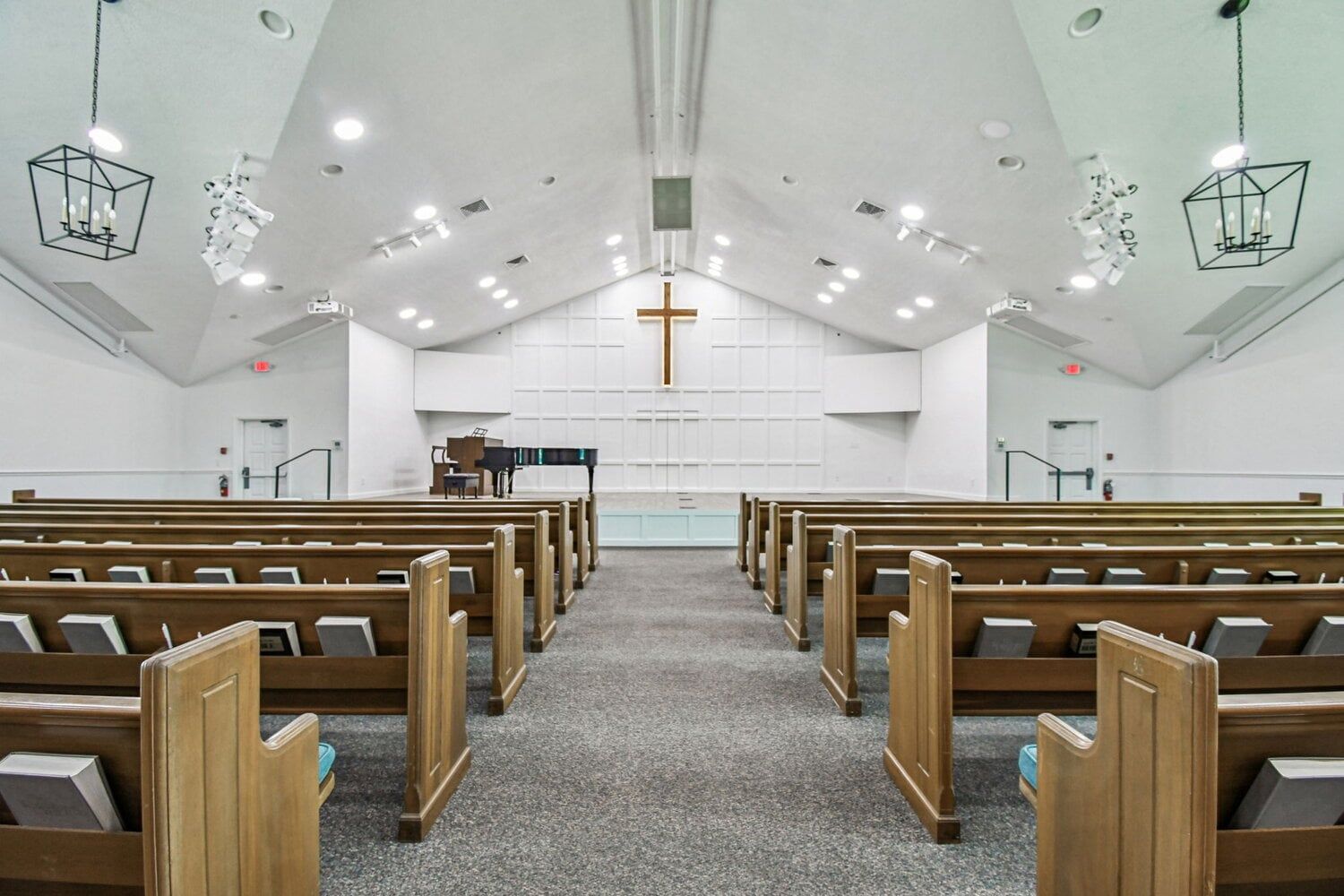Church interior with central aisle and cross detail — Roser Memorial Community Church, Anna Maria, FL