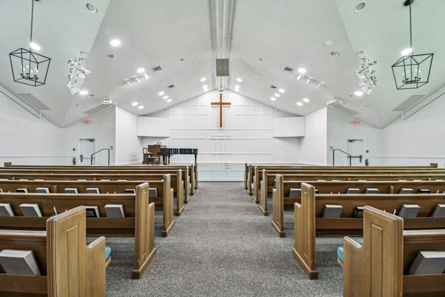 Church interior with central aisle and cross detail — Roser Memorial Community Church, Anna Maria, FL