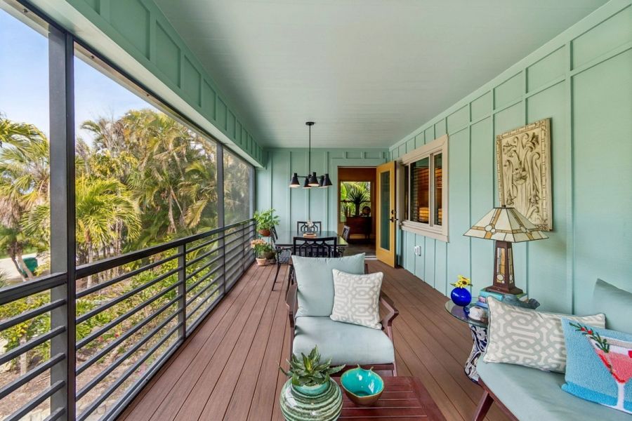 Exterior screened porch lounge seating teal walls wood deck — Custom home addition, Longboat Key