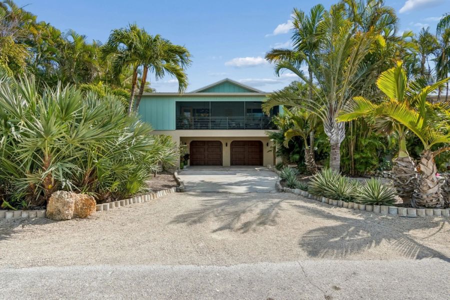 Exterior front elevation teal siding screened porch double garage — Custom home addition, Longboat Key