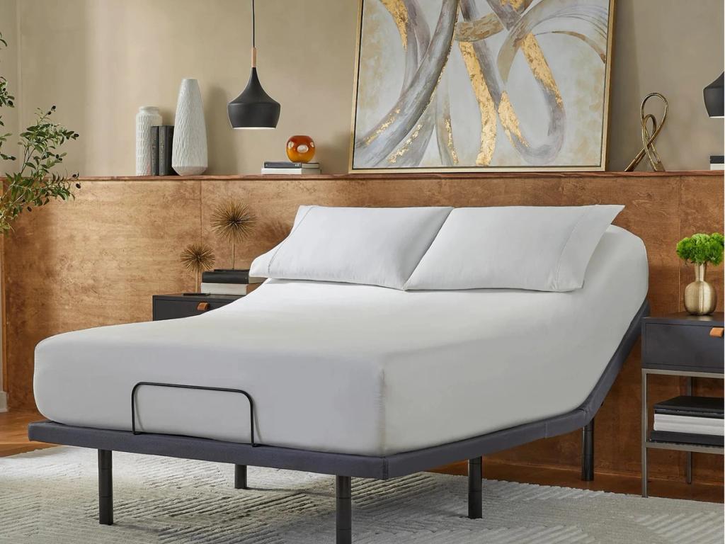 Adjustable base with the head of the mattress raised in a bedroom